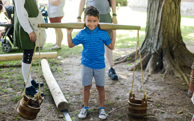 Child Plays With Colonial Chores