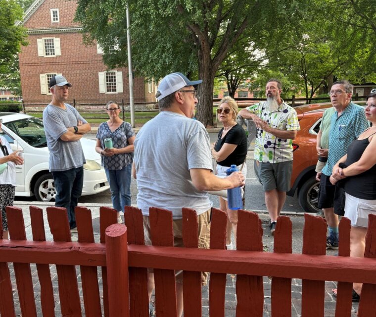 A History Center staff member leads a group of visitors on a tour of downtown York's historic sites.