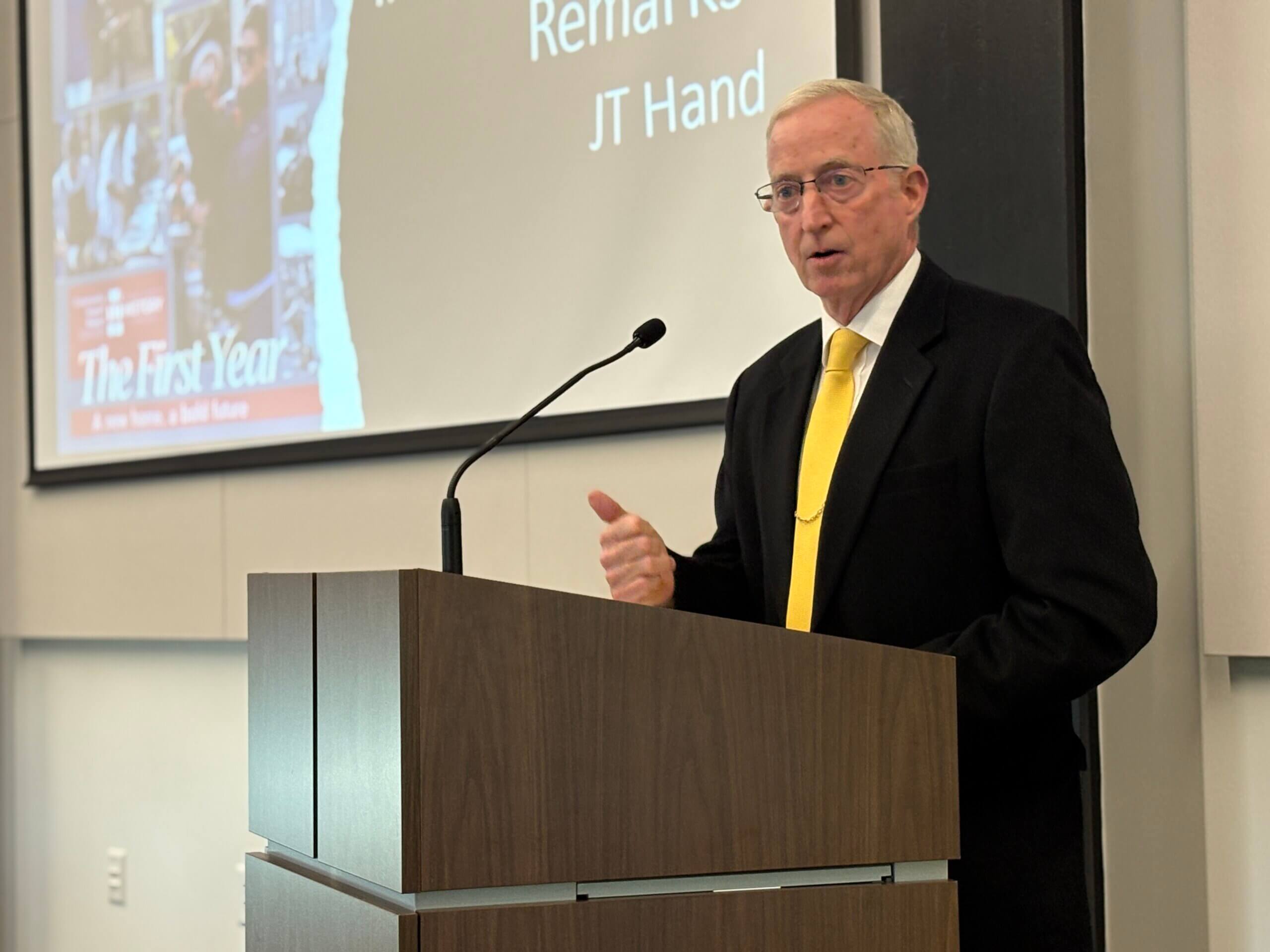 JT Hand speaking at a podium