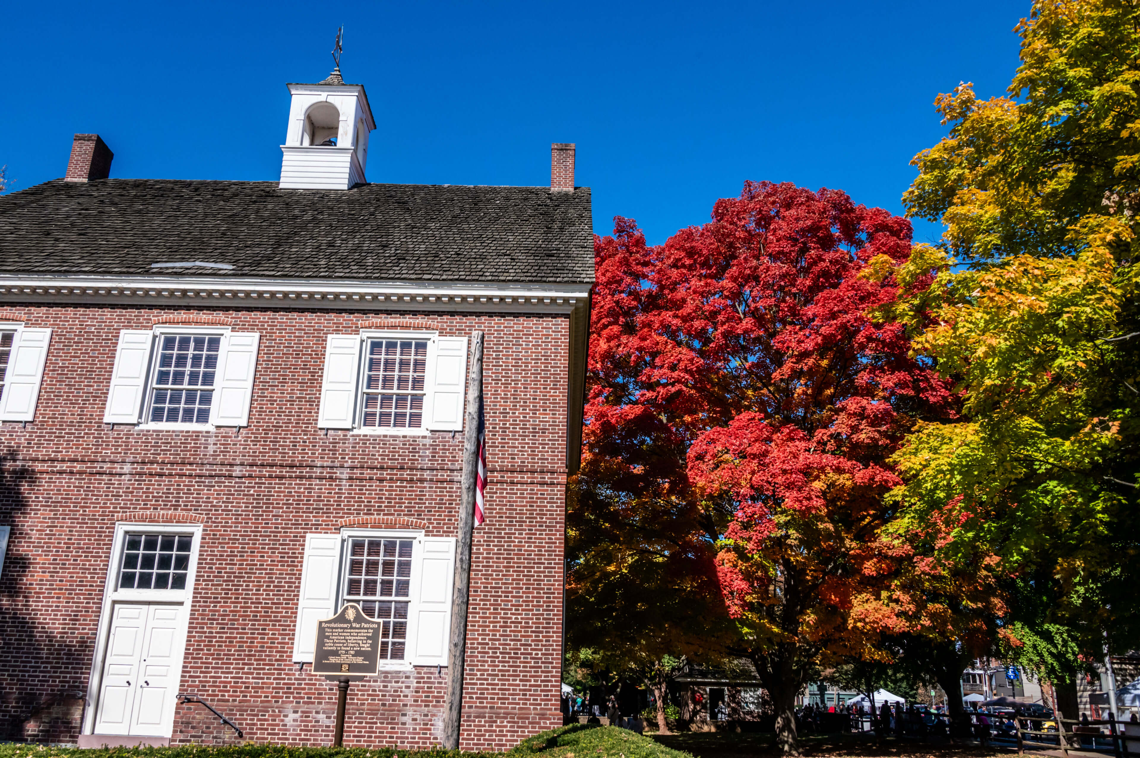 photo of Colonial Courthouse during Oyster Festival with fall trees in background